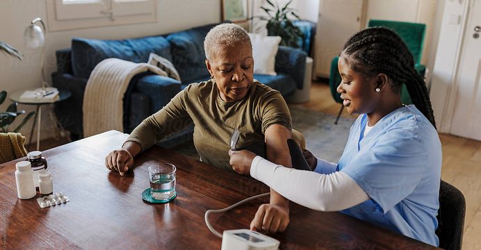 Resident checking blood pressure at home