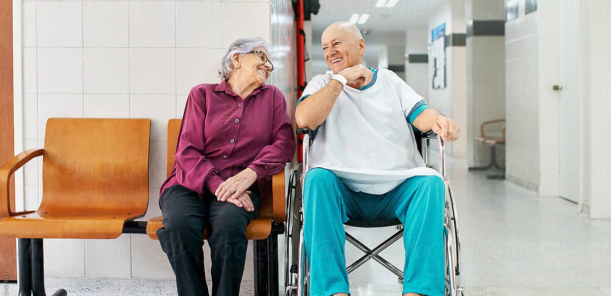 Couple smiling together in a care center hallway