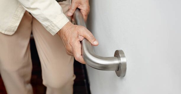 Hand holding a bathroom grab bar