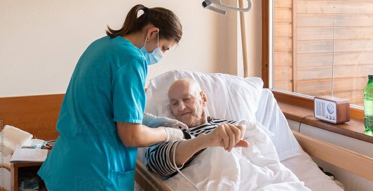 Nurse checking on a resident in bed