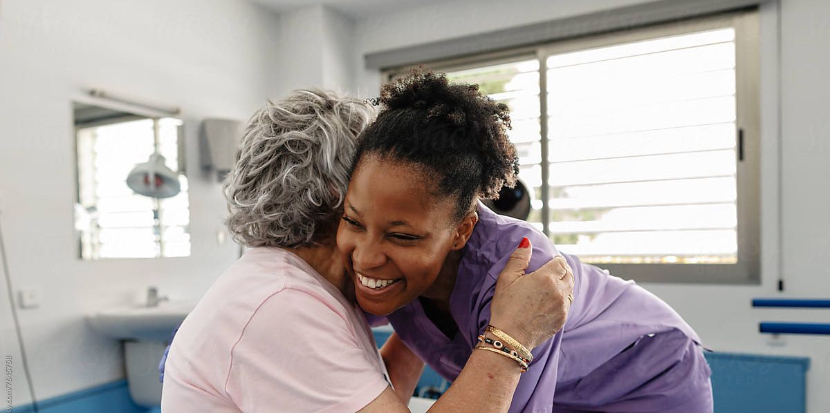 Nurse sharing a warm hug with a resident