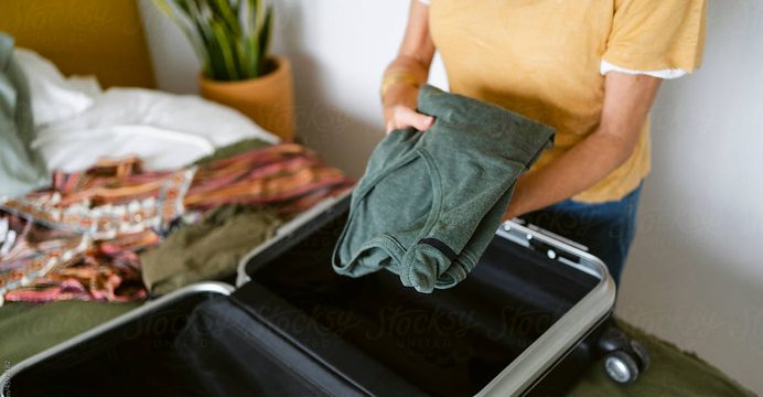 Packing clothes into a suitcase for admission day