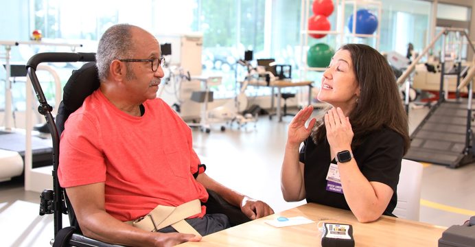 Speech therapist working with a resident in a wheelchair