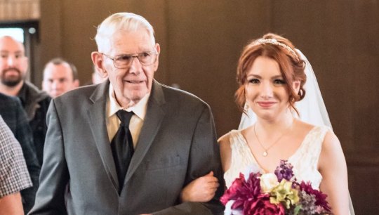 Harold walking his granddaughter Emma down the aisle